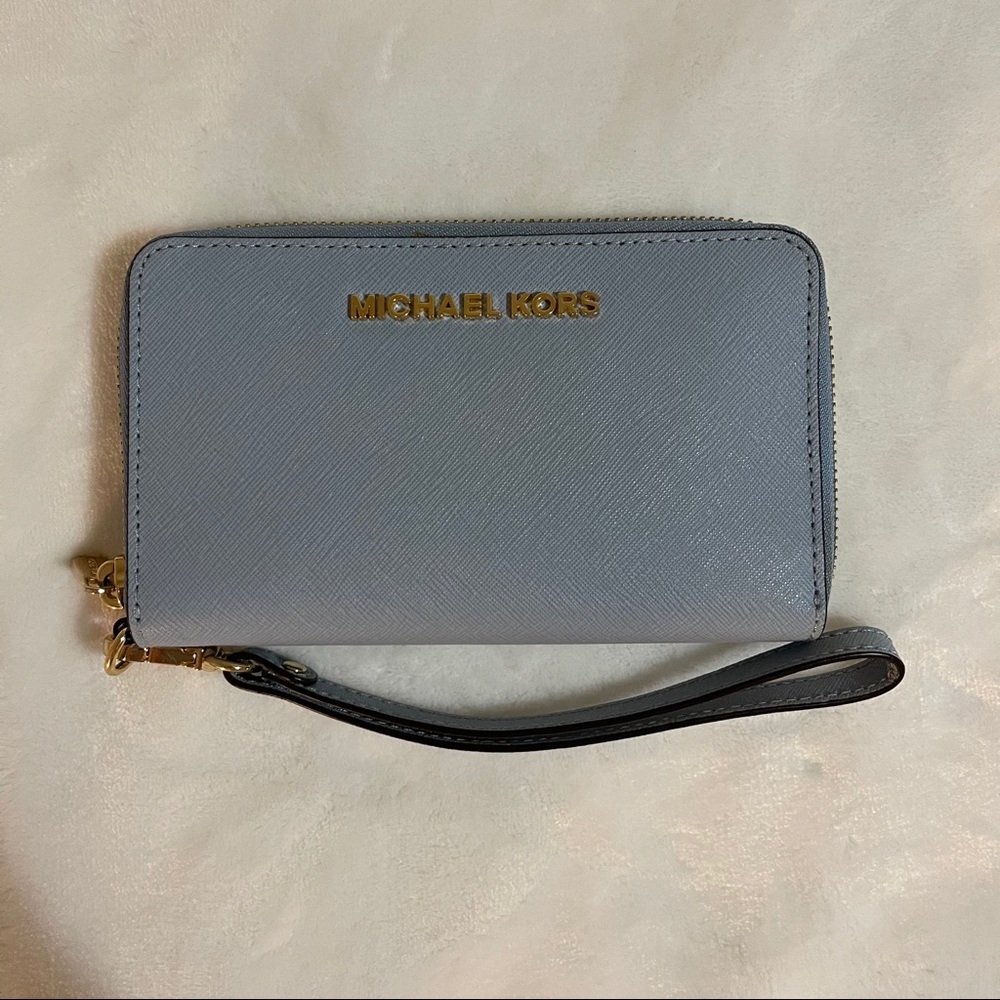 michael kors wristlet in a dusty/baby blue color!